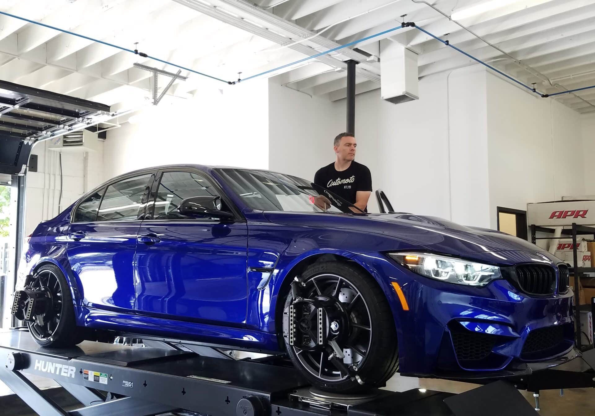 a bmw is being serviced by a local mechanic