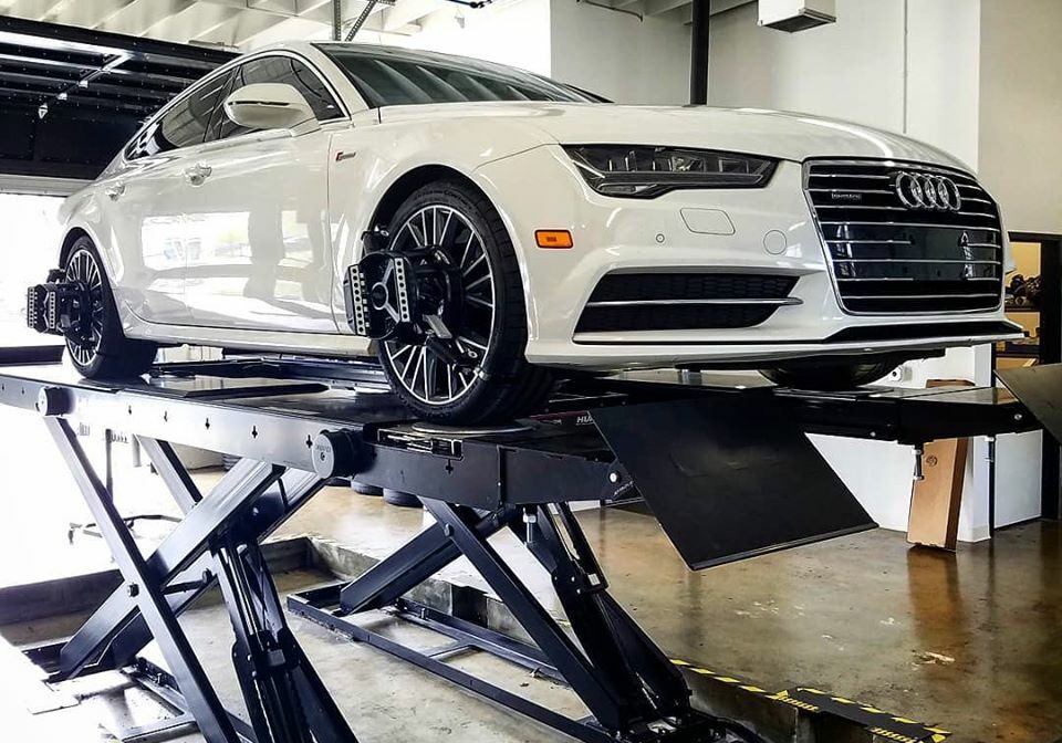 a mechanic works on an audi in an audi service center